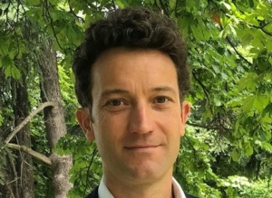 Portrait of Sébastien Seux in a suit in a forest background